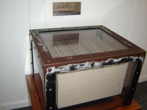 1986 Ford Bronco - Display case containing one million dollars in ten dollar bills, with a sign indicating the amount.