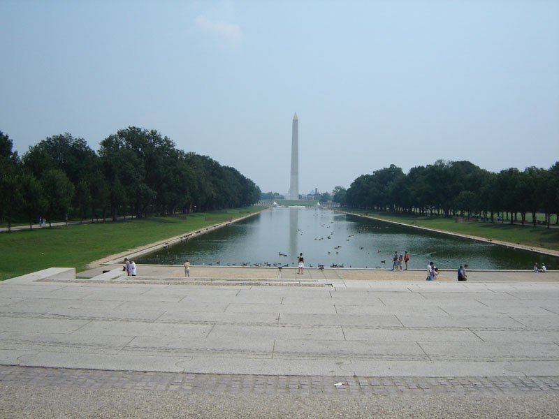 Washington Monument reflecting pool with trees and people