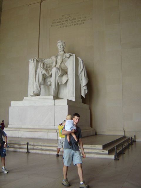 1986 Ford Bronco - A man carries a child past the seated Lincoln statue at the Lincoln Memorial.