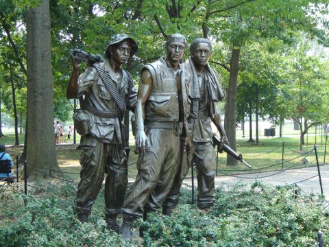 1986 Ford Bronco - Bronze statues of soldiers stand in a park, with trees and foliage in the background.