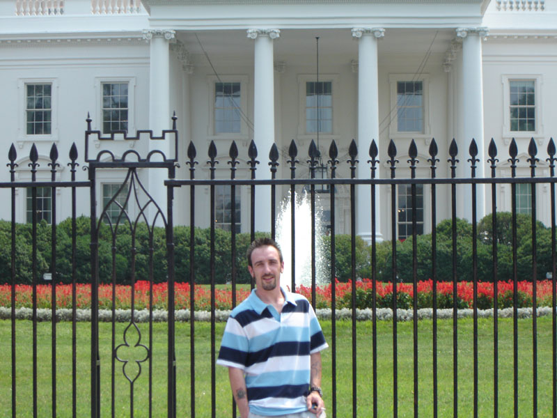 Man standing in front of the White House fence