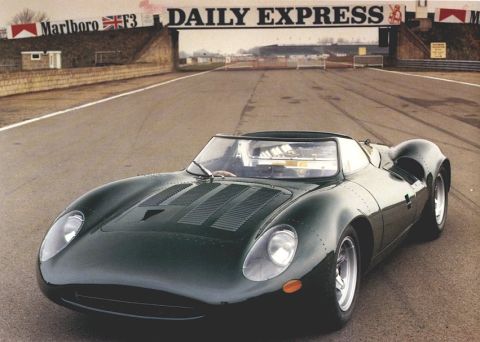 1997 Ford Crown Victoria - A dark green race car sits on a track with a "DAILY EXPRESS" sign visible above the entrance.