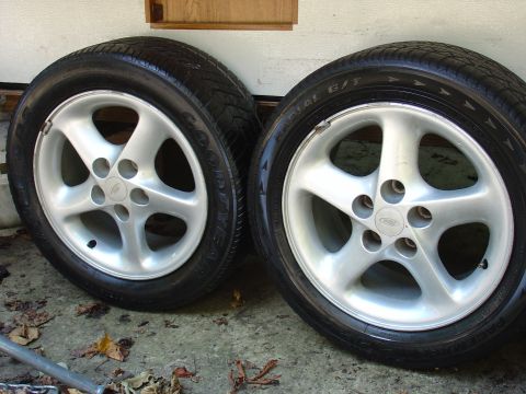 1993 Ford Probe - Two alloy wheels with Goodyear tires are shown, one a Ford logo.