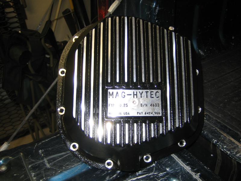 Black finned Mag-Hytec aluminum differential cover sitting in a truck bed