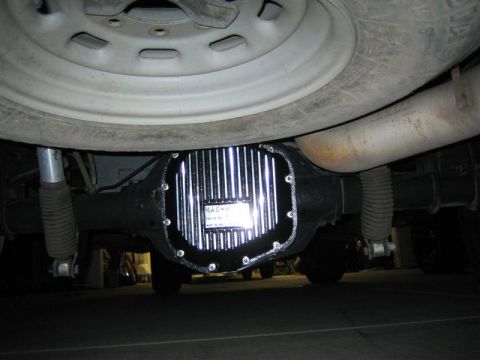 1999 Ford F-250 - Close-up of an aftermarket differential cover, showing fins and some text.