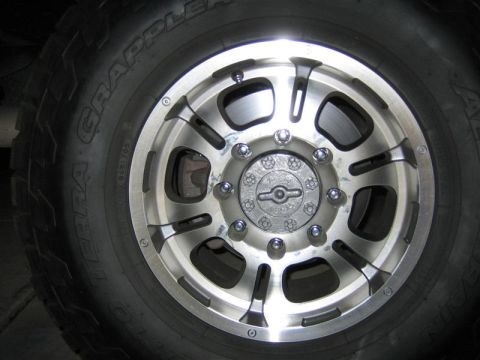 1999 Ford F-250 - A detailed view of a vehicle's wheel and tire assembly, highlighting the rim's design and tread pattern.