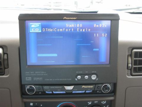 1999 Ford F-250 - The dashboard of a vehicle features a Pioneer stereo system displaying CD track information and the time.