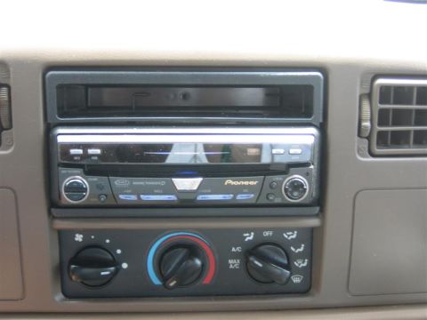 1999 Ford F-250 - The dashboard of a vehicle displays a Pioneer stereo system and climate control knobs.