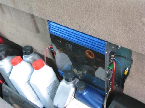1999 Ford F-250 - Car amplifier and bottles stored in a vehicle's cargo area.