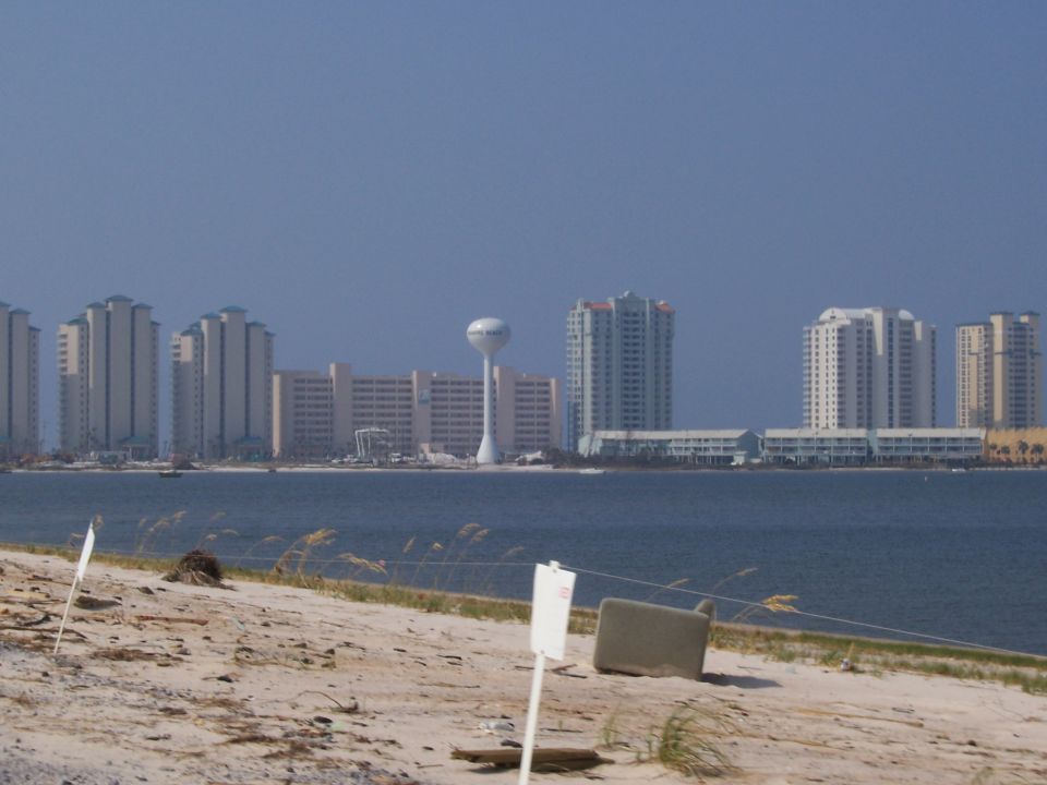 Beachfront buildings and a water tower across the water