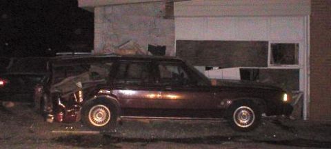 1987 Ford Crown Victoria LTD - Maroon station wagon with significant rear damage, parked in front of a garage. The vehicle appears to be from 1987.