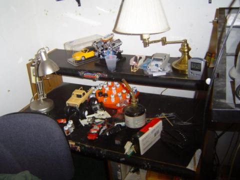 1979 Ford Bronco - A desk displays various model cars and hobby tools, suggesting a collection or project in progress.