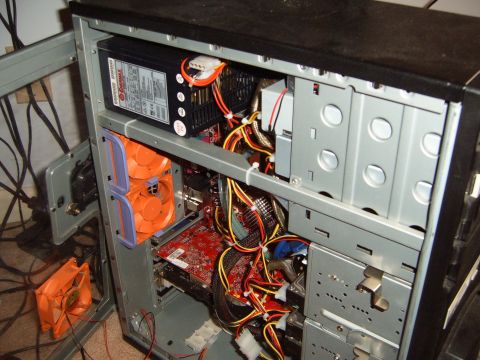 1988 Ford Bronco - The internal components of a computer tower are visible, including the power supply, fans, and numerous wires.