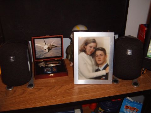 1988 Ford Bronco - A framed photograph of a couple is displayed on a wooden surface alongside other personal items.