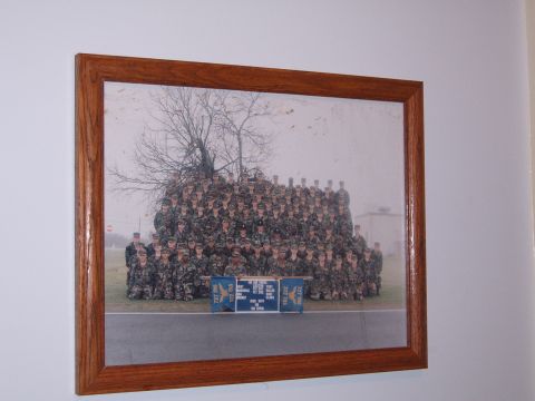 1988 Ford Bronco - A framed group photograph displays military personnel in formation, with a banner placed before them.