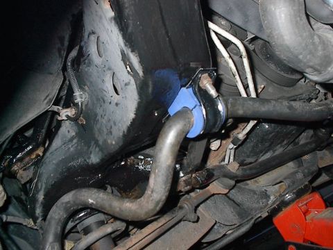 1985 Mercury Grand Marquis - Close-up of a vehicle's undercarriage, focusing on suspension parts and a sway bar bushing.
