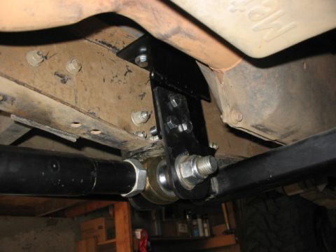 1995 Ford Bronco - Close-up view of a custom suspension bracket and linkage installed on the underbody of a vehicle.