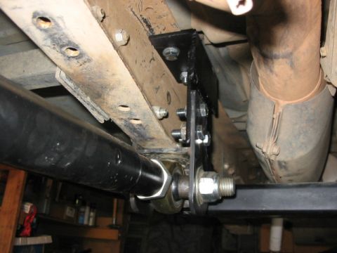 1995 Ford Bronco - Custom bracket installed on vehicle frame, showing suspension and exhaust components.