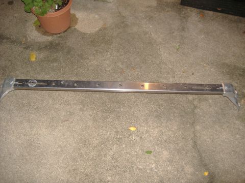 1996 Ford Bronco - This is a metal bar with mounting brackets and holes, possibly a roof rack component.