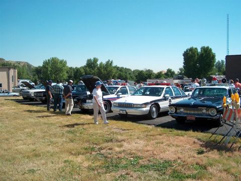 2001 Ford Crown Victoria - Cars and people gathered outdoors at an event, with some car hoods open.