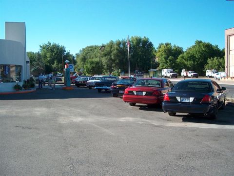 2001 Ford Crown Victoria - A dark blue 2001 Ford Crown Victoria is parked in a lot with other vehicles.
