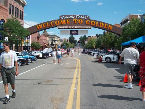 2001 Ford Crown Victoria - A street scene in Golden, Colorado, with parked cars and a welcome archway.