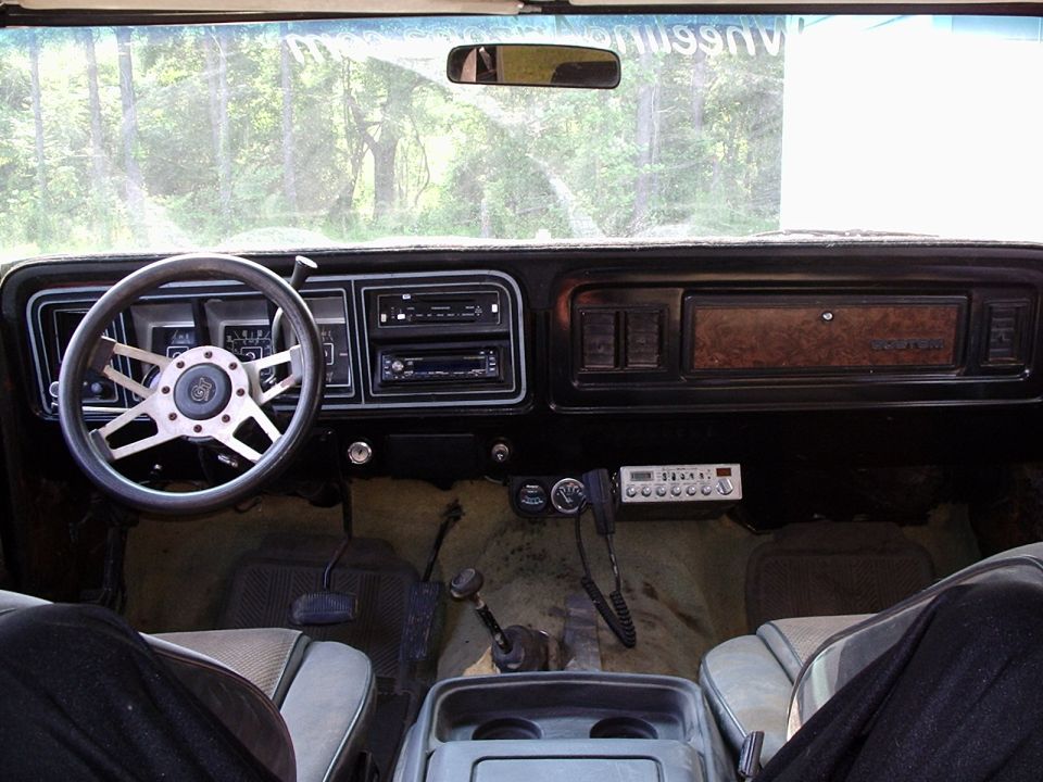 Ford Bronco interior dash with chrome wheel, CB radio and manual shifter