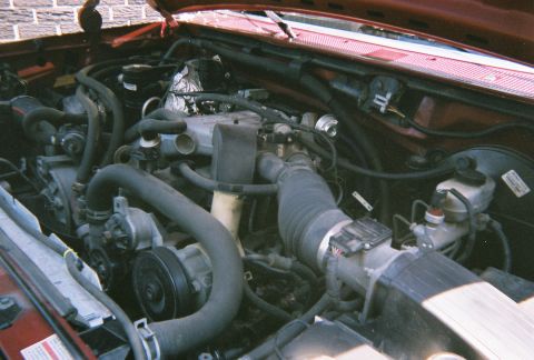 1996 Ford F-150 - Close-up view of the engine compartment, showing various mechanical parts and wiring.