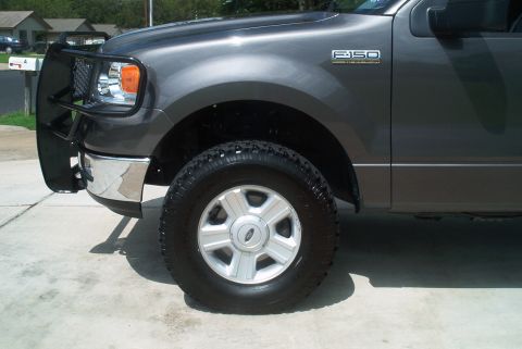 1986 Ford Bronco - This gray Ford F-150 truck is equipped with a brush guard and aftermarket wheels.