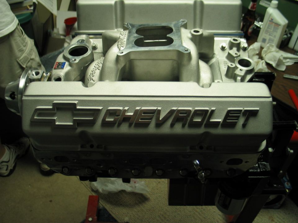 Close-up of a Chevrolet engine intake manifold with the Chevrolet logo visible