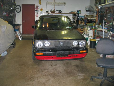 1986 Volkswagen Cabriolet - A black Volkswagen Golf/Rabbit convertible is parked in a garage with tools and supplies visible in the background.