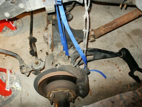 1996 Ford Bronco - This image shows the underside of a vehicle, focusing on the suspension and drive shaft assembly.