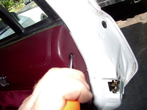 1990 Lincoln Town Car - After this 3 rd screw and the fourth one on the inner side are removed you just pull from the bottom and off comes the door panel.