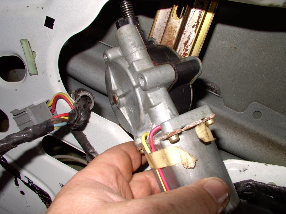 After the three bolts are out and you've unplugged the motor, just pull the motor out far enough to get at it. This way you don't have to disturb, remove or adjust the cables at all.