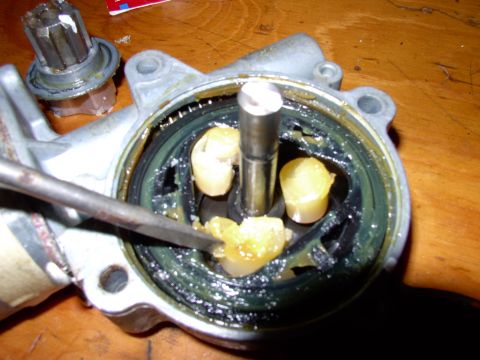 1990 Lincoln Town Car - With the center gear off (behind motor housing on bench) you can see those little nylon gear plugs have been crushed alright.