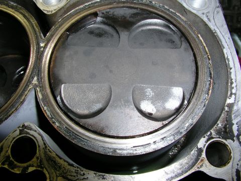 1996 Ford Probe - Close-up view of an engine piston, showing signs of wear and carbon deposits.