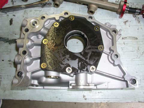 1996 Ford Probe - Close-up of a disassembled oil pump housing, showing internal components and gasket.