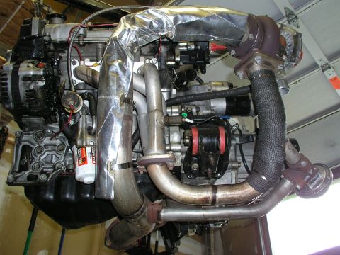 1996 Ford Probe - A turbocharged engine assembly is shown, suspended and ready for installation.