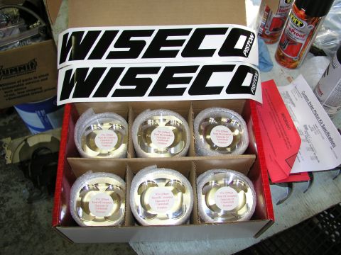 1996 Ford Probe - A box containing six Wiseco pistons is shown, along with two Wiseco decals and some paperwork.
