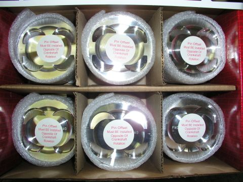 1996 Ford Probe - Box of six new pistons, each with installation instructions on a sticker.