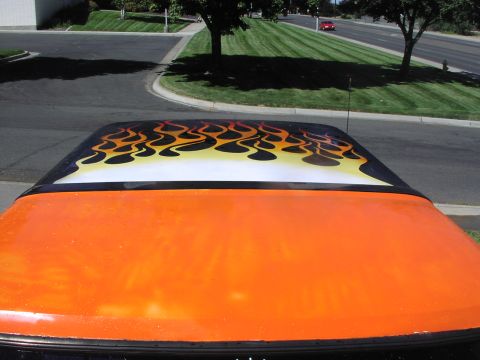 1979 Ford Bronco - The roof of an orange vehicle features custom flame graphics.
