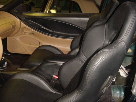 1995 Ford Mustang - Interior of a 1995 Ford Mustang, black leather seats and tan door trim.