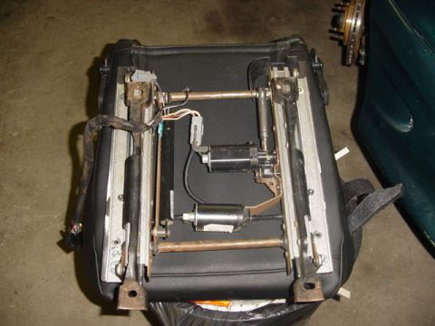 1995 Ford Mustang - A disassembled power seat mechanism is shown with its internal components visible.