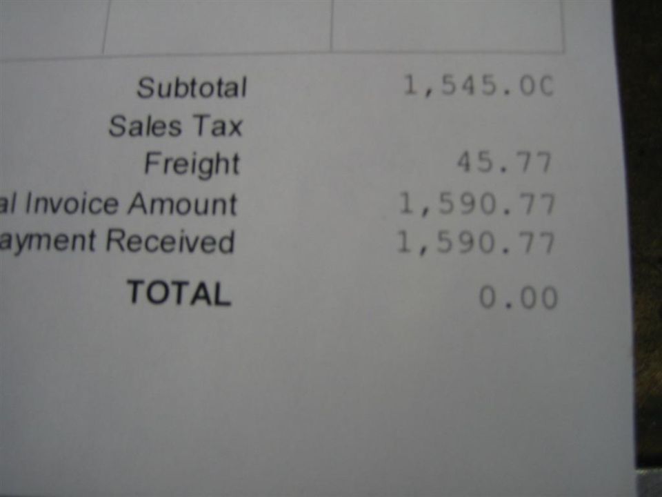 Close-up of a paid invoice showing $1,590.77 total and $0.00 balance due
