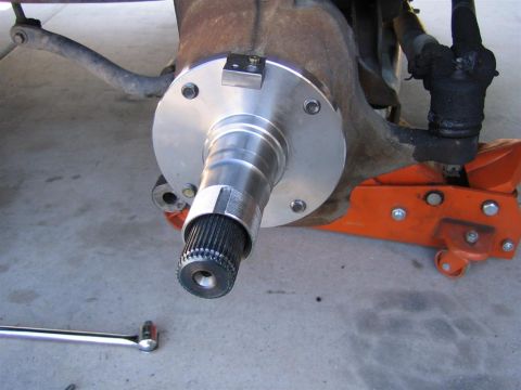1999 Ford F-250 - Close-up of a vehicle's front wheel hub assembly, possibly undergoing maintenance or repair.