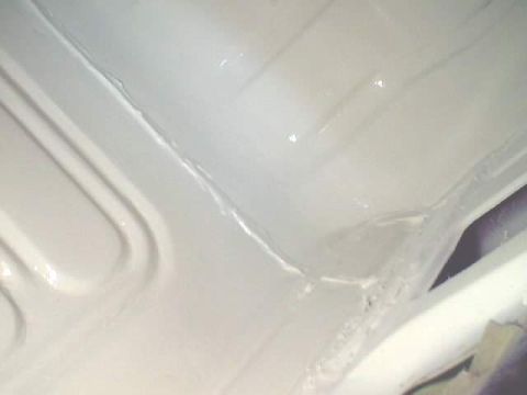 1966 Ford Fairlane - Close-up view of a painted car floor pan, showing structural details and seams.