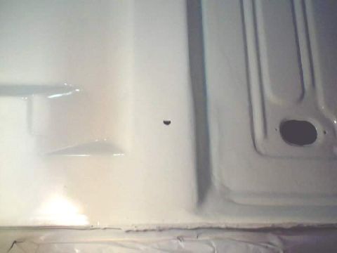 1966 Ford Fairlane - The underside of a vehicle's floor pan is shown, recently painted white.