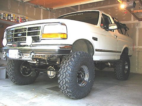 1995 Ford Bronco - This modified 1995 Ford Bronco features a lifted suspension and aggressive off-road tires, giving it a commanding presence.