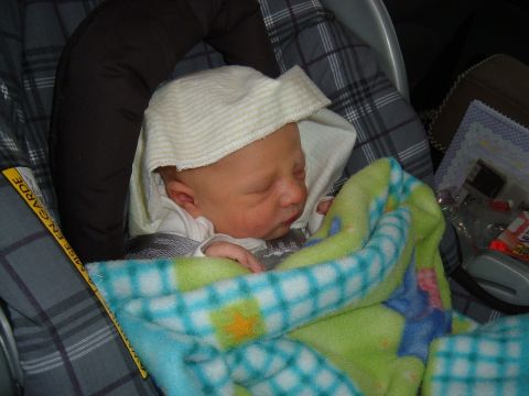 1979 Ford Bronco - Baby is secured in a car seat with a blanket.