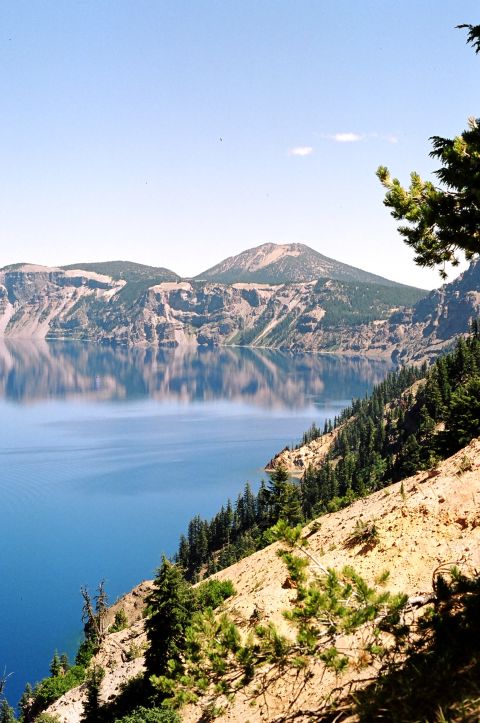 1979 Ford Bronco - A scenic view of Crater Lake, Oregon, with its deep blue waters reflecting the surrounding mountains and sky.